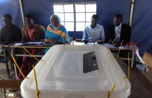 Polling station officials sit behind a ballot box during a referendum on constitutional reforms in Dakar on March 20, 2016 (AFP Photo/Seyllou)