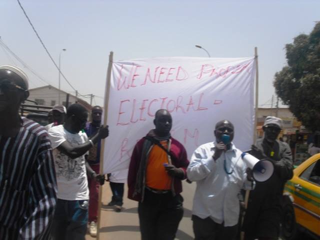 Gambia opposition member who died in custody. Solo Sandeng with the megaphone with UDP protesters at Westfield Junction.