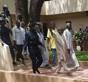 Lawyer Darboe and his supporters being led away in handcuffs