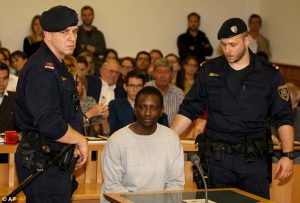 Abdou I is pictured (left) being brought to court in Vienna 