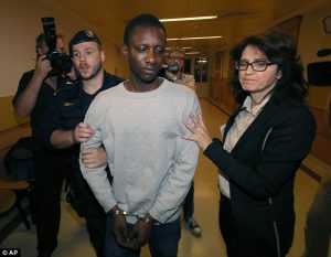 Abdou I is pictured being brought to court in Vienna